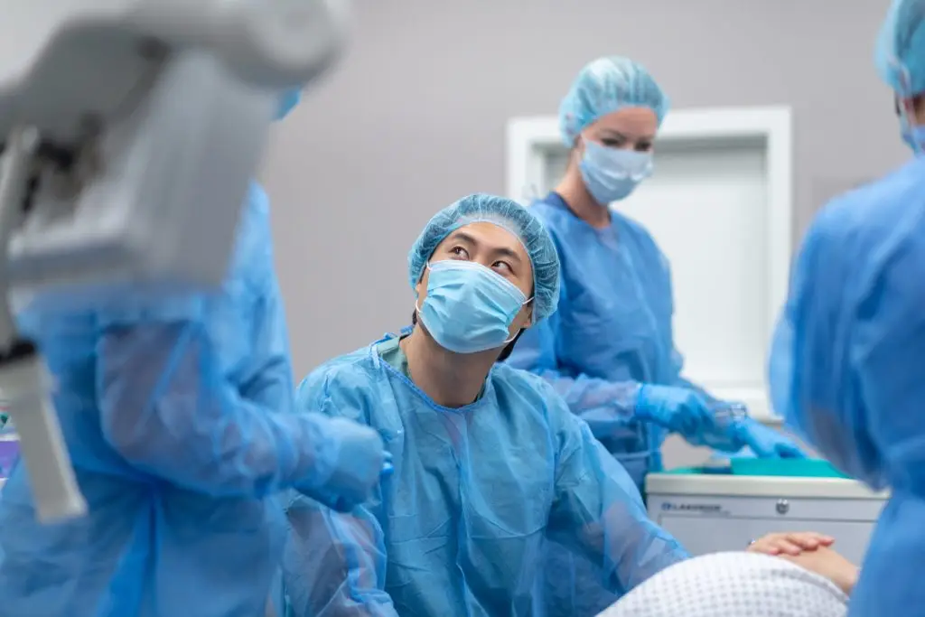 doctor with team of surgeons prepares to perform cesarean section surgical operation